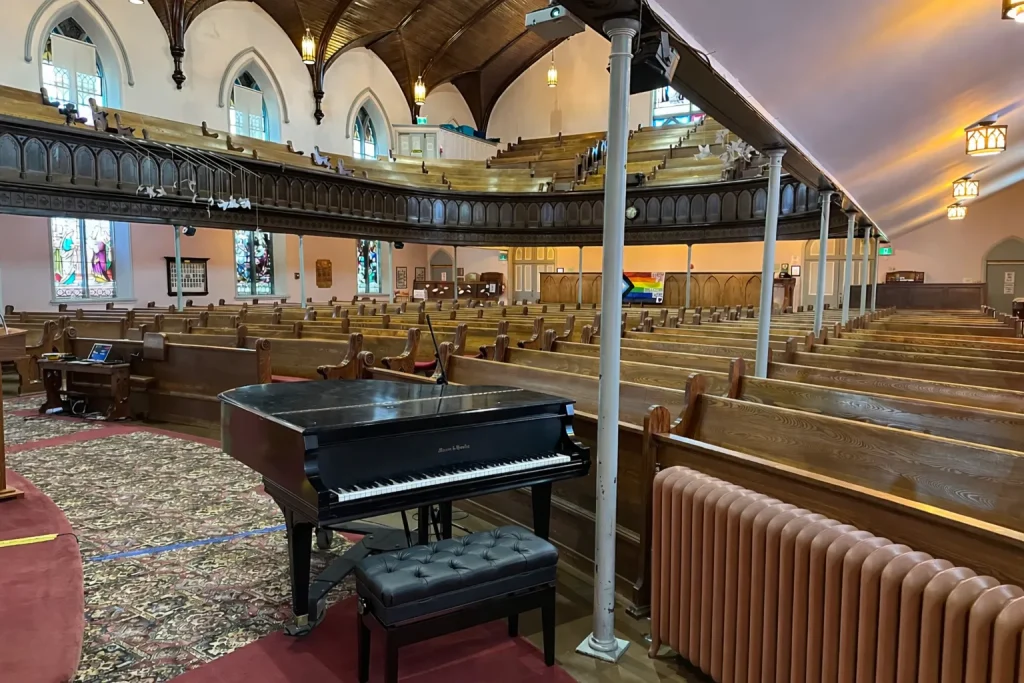 Sanctuary piano with pews